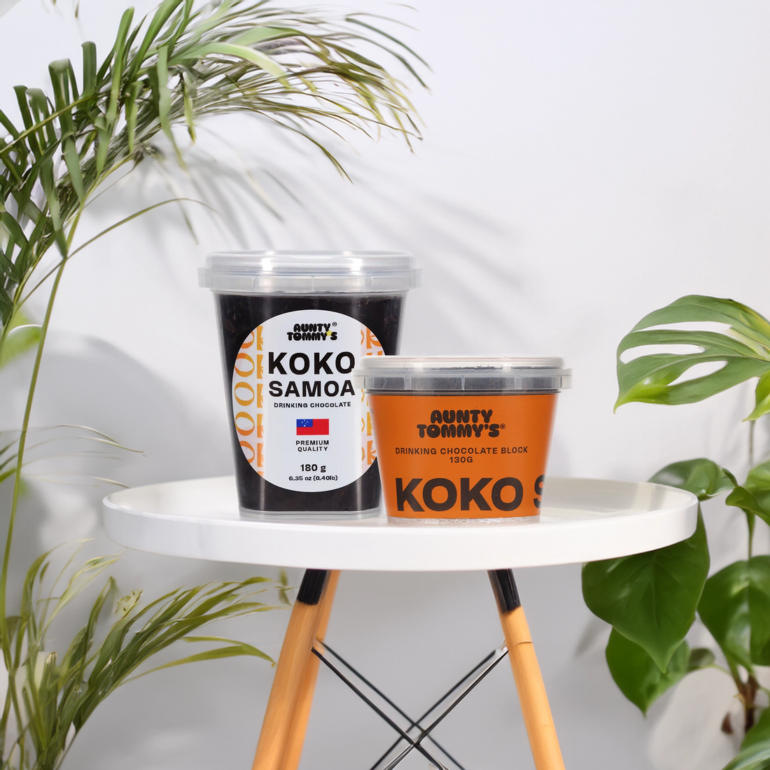koko blocks on a small white stool next to pot plants