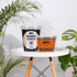 koko blocks on a small white stool next to pot plants
